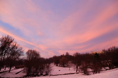 Gün batımının ışınlarında güzel bir manzara. Kış çizimleri.