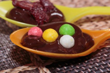 Decorating chocolate with various sprinkles. Close-up.