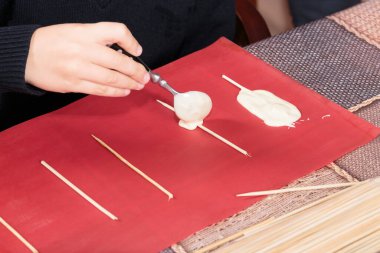 The process of making chocolates on sticks. Master Class. Close-up.