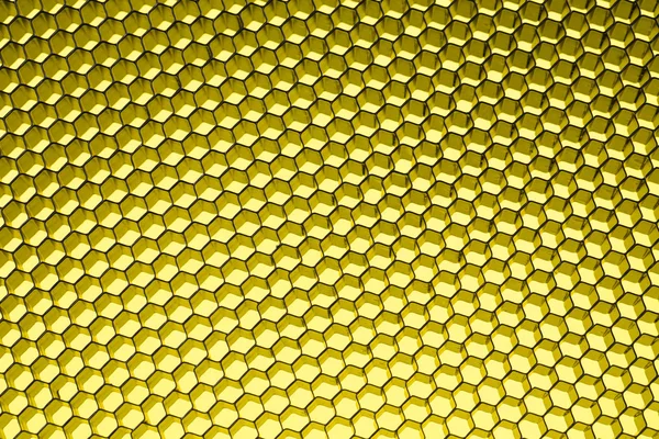 Honeycomb grid against yellow — Stock Photo, Image