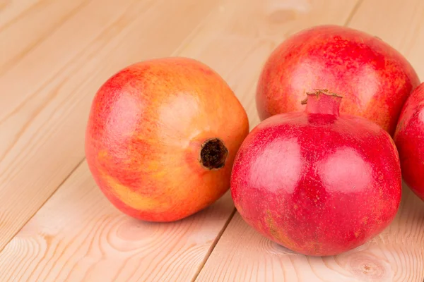 Pomegranate fruits on wooden background. — Stock Photo, Image