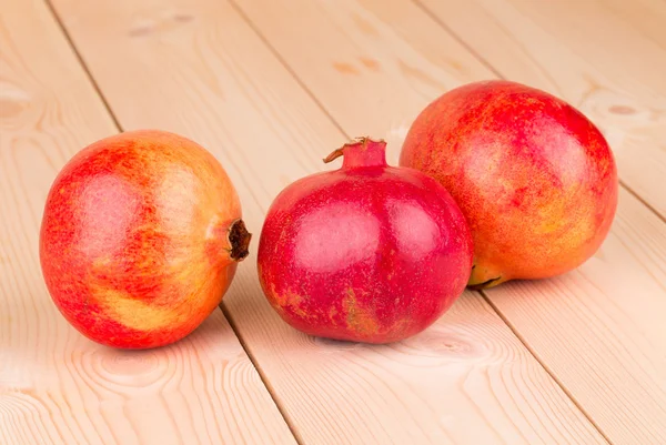 Pomegranate fruits on wooden background. — Stock Photo, Image