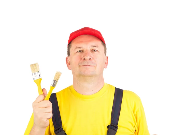 Trabajador muestra pinceles de pintura . — Foto de Stock