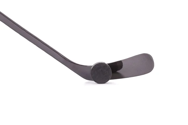 Black ice hockey stick and puck. — Stock Photo, Image