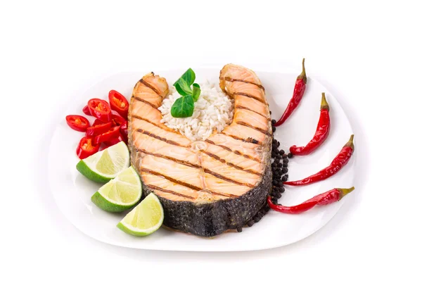 Grilled salmon steak with vegetables on plate. — Stock Photo, Image