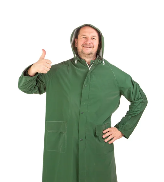 Uomo sotto la pioggia lungo cappotto verde . — Foto Stock