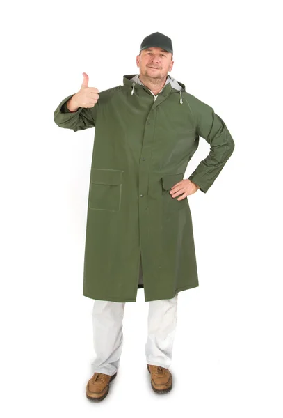 Man in green winter vest showing thumb up — Stock Photo, Image