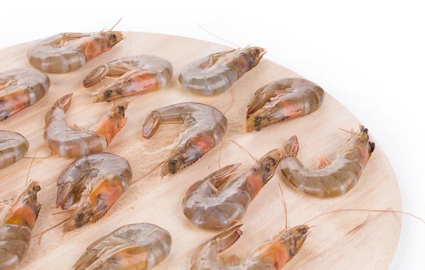 Raw shrimps on wooden platter. — Stock Photo, Image