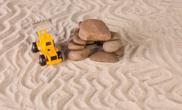 Yellow loader near stones. — Stock Photo, Image