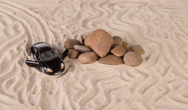 Black racing car on the sand. — Stock Photo, Image