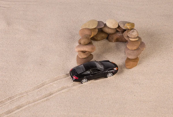 Black racing car on the sand. — Stock Photo, Image