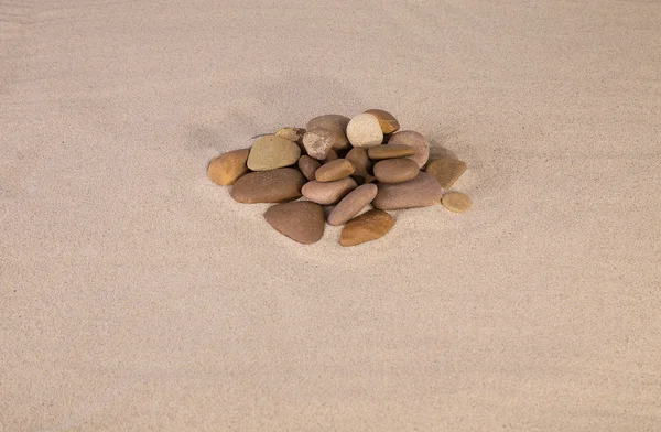 Heap of rocks on sand. — Stock Photo, Image