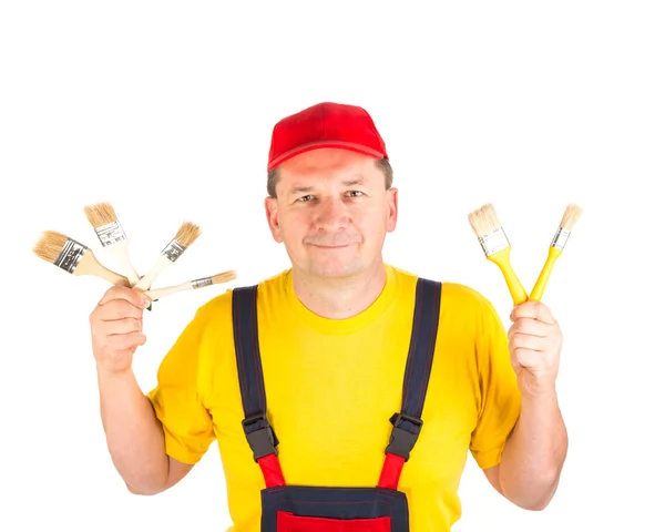 Worker showing brushes. — Stock Photo, Image