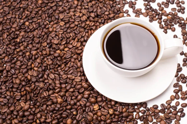 Cup on coffee beans — Stock Photo, Image