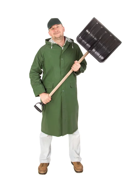 Man in long vest with shovel. — Stock Photo, Image