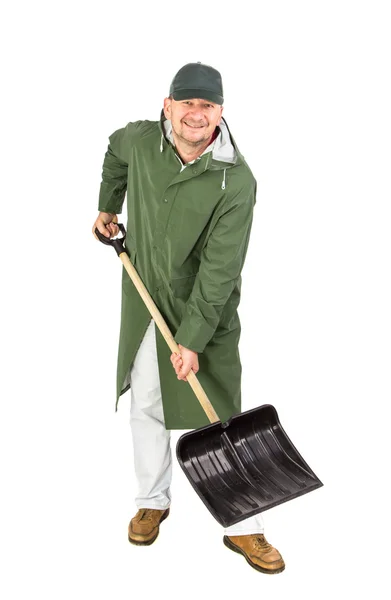 Man in long vest with shovel. — Stockfoto