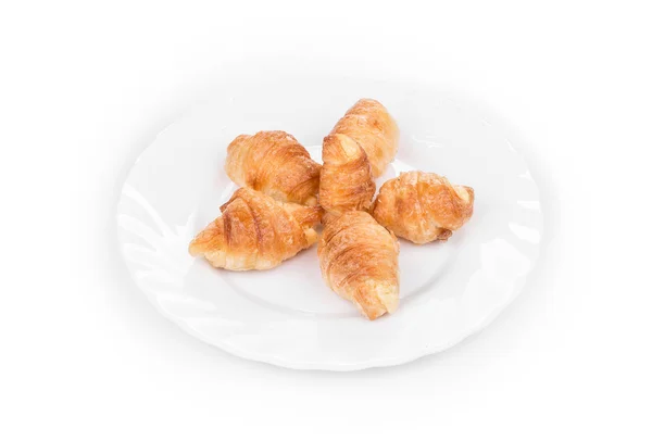 Croissant saboroso na placa . — Fotografia de Stock