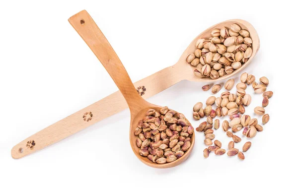 Wooden spoons with pistachios. — Stock Photo, Image