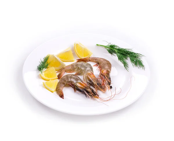 Raw shrimps on plate with lemon — Stock Photo, Image