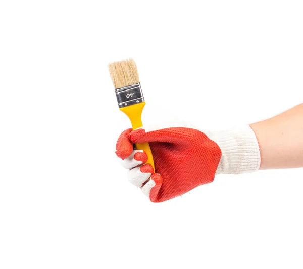 Hand i handskar håller penseln. — Stockfoto