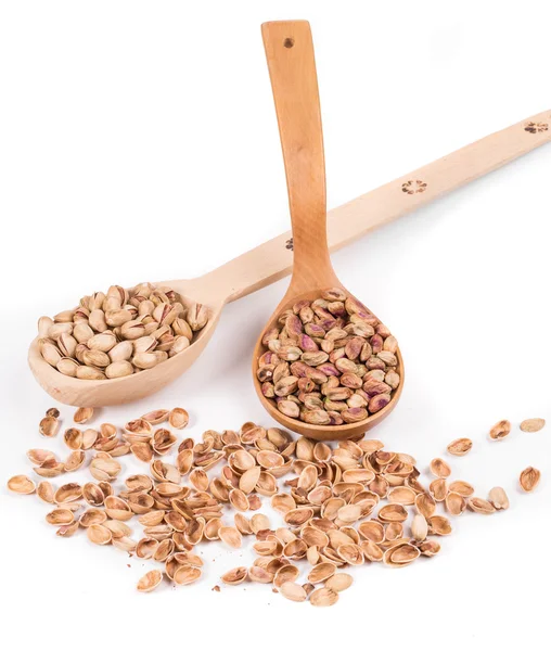 Wooden spoons with pistachios. — Stock Photo, Image