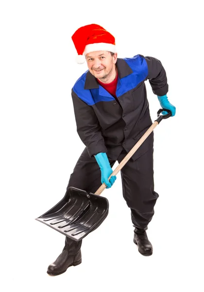 Operaio in cappello di Babbo Natale con pala — Foto Stock