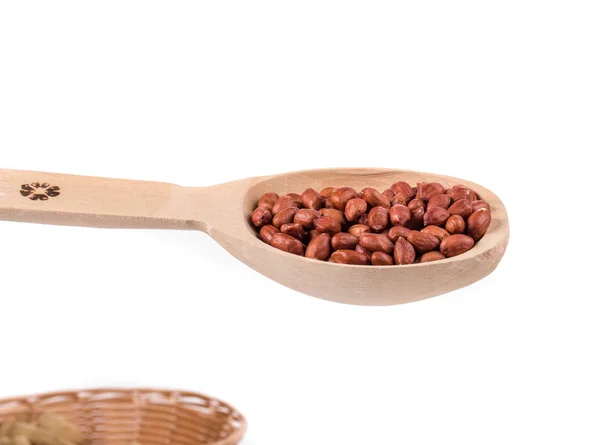 Wooden spoon full of peanuts. — Stock Photo, Image