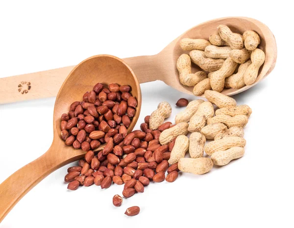 Wooden spoons full of peanuts. — Stock Photo, Image