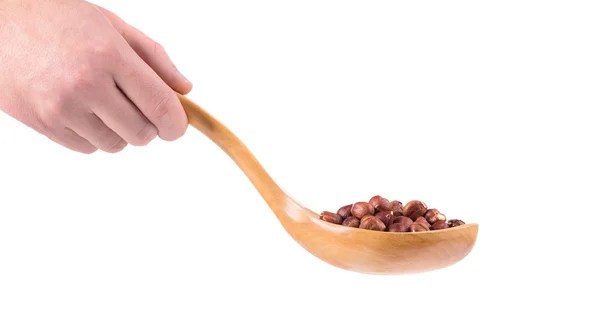 Cuchara de madera con nueces en la mano . —  Fotos de Stock