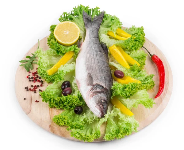 Fresh seabass fish on lettuce. — Stock Photo, Image