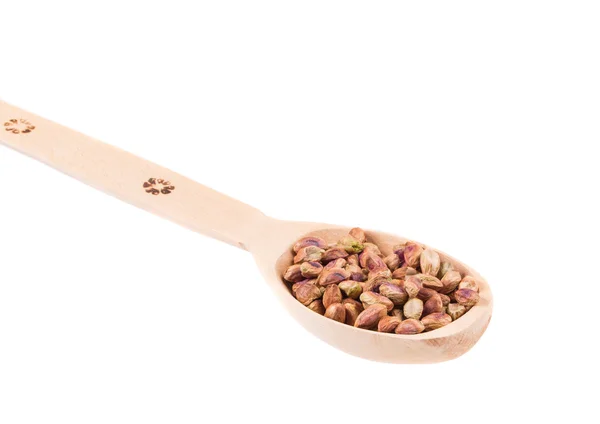 Wooden spoon with pistachios. — Stock Photo, Image