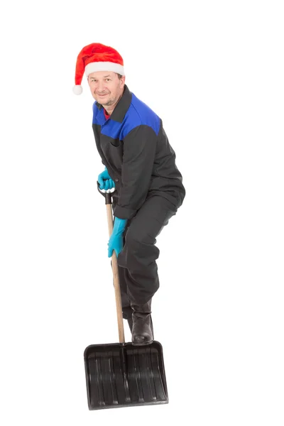 Worker in santa hat holding shovel. — Stock Photo, Image