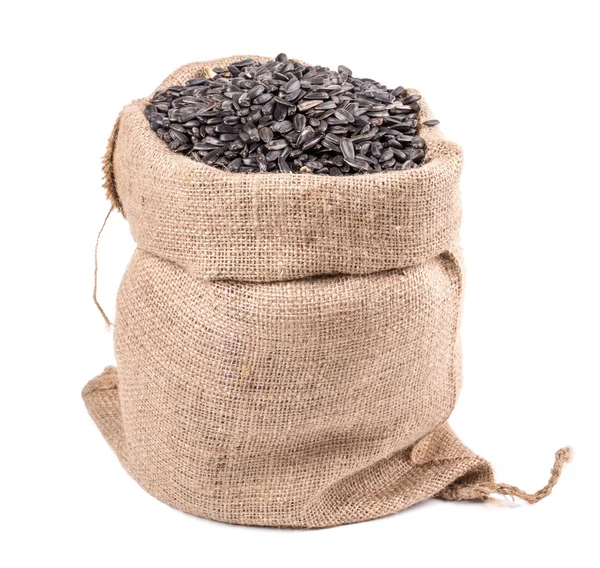 Czarne nasiona słonecznika w torbie. — Zdjęcie stockowe