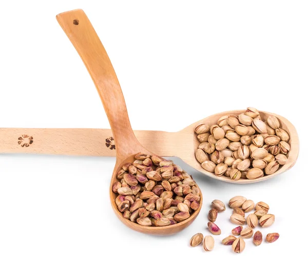 Two wooden spoons with pistachios. — Stock Photo, Image