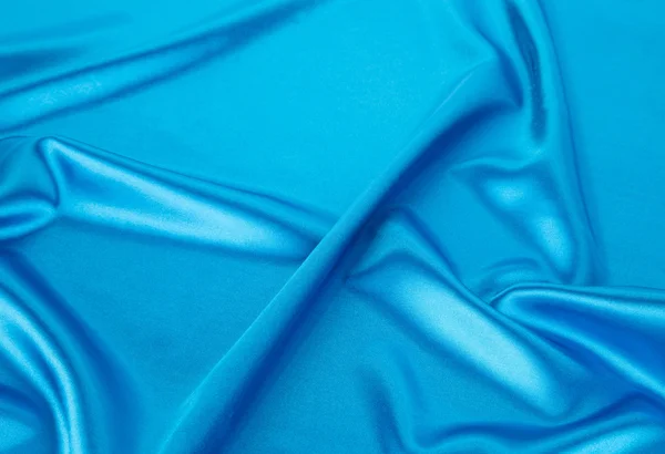 布の青いシルクの柔らかい襞. — ストック写真
