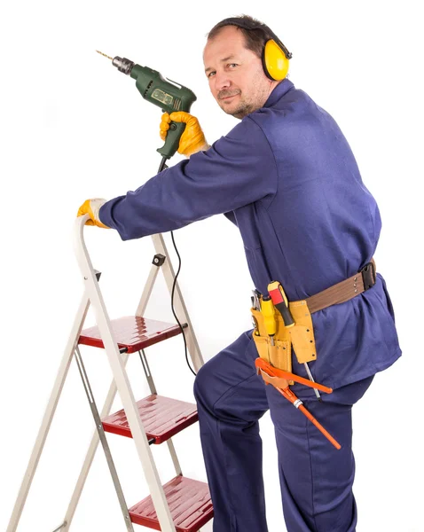 Trabajador con taladro en escalera — Foto de Stock
