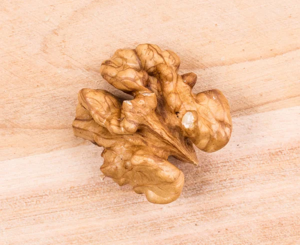 Walnut kernel on wooden background. — Stock Photo, Image