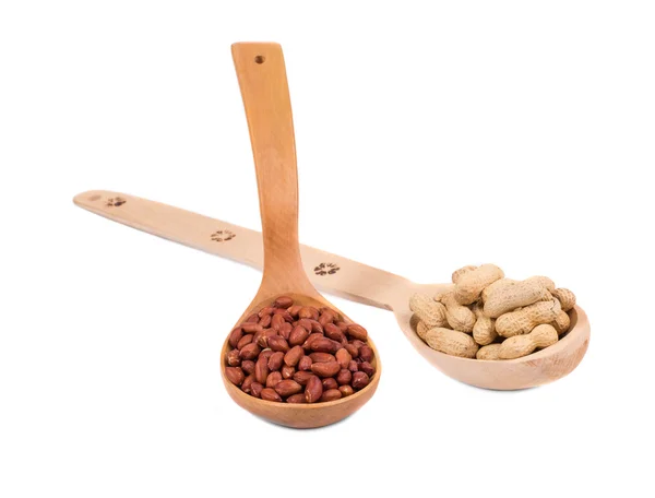 Wooden spoons full of peanuts. — Stock Photo, Image