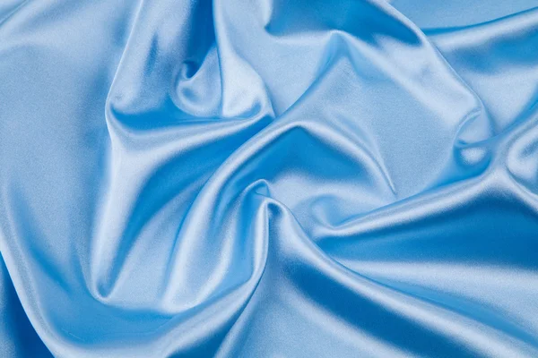 Синий шелковый драпировочный фон . — стоковое фото