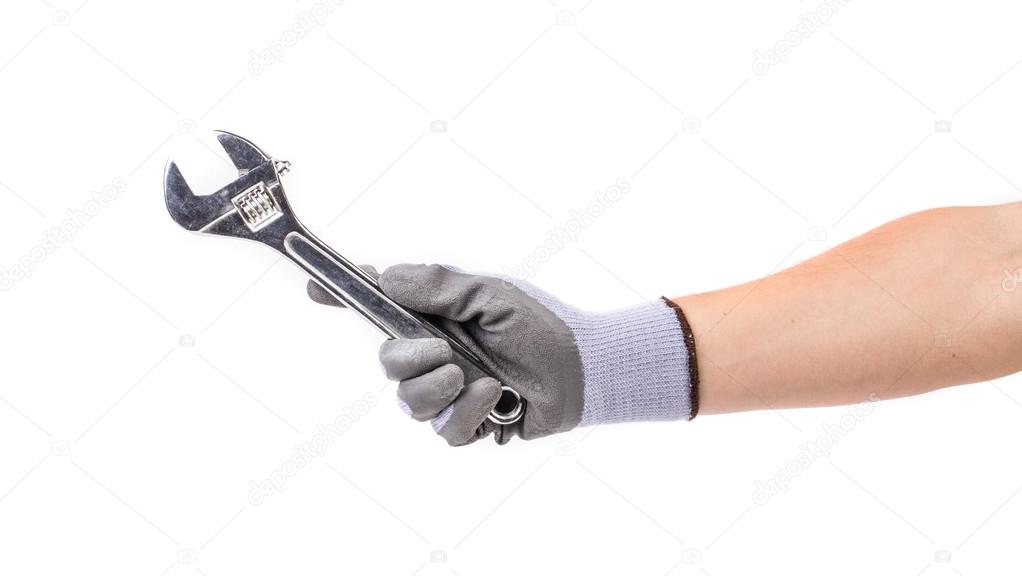 Hand  holding adjustable wrench.