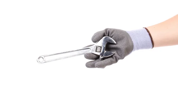 Hand in glove holding wrench. — Stock Photo, Image