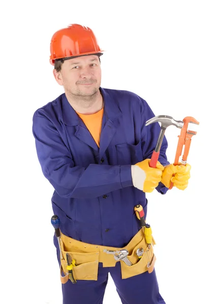 Trabajador en casco protector sosteniendo martillos . —  Fotos de Stock