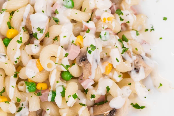 Pasta with with corn, peas, sausage and  white sauce. — Stock Photo, Image