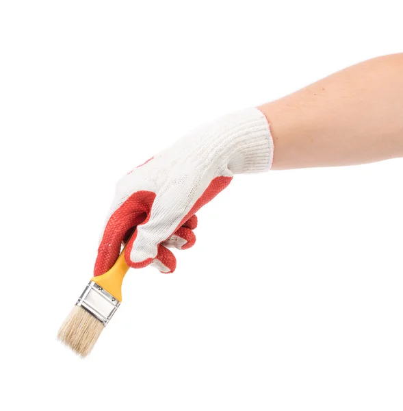 Hand in gloves holds brush. — Stock Photo, Image