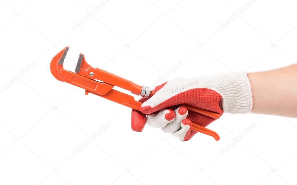 Hand in gloves holding gas wrench.
