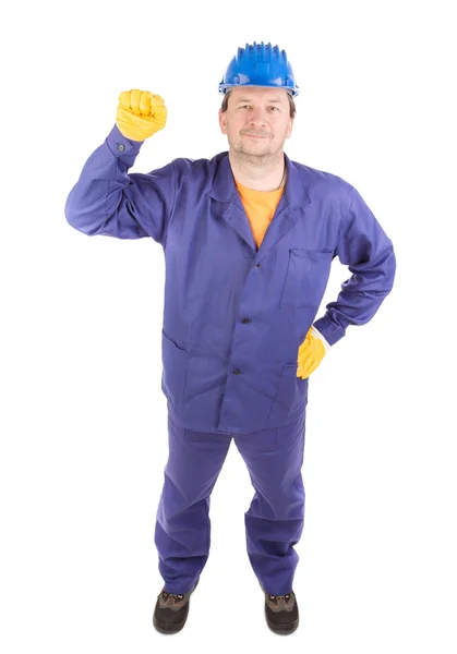 Homem em roupas de trabalho mostra punho — Fotografia de Stock