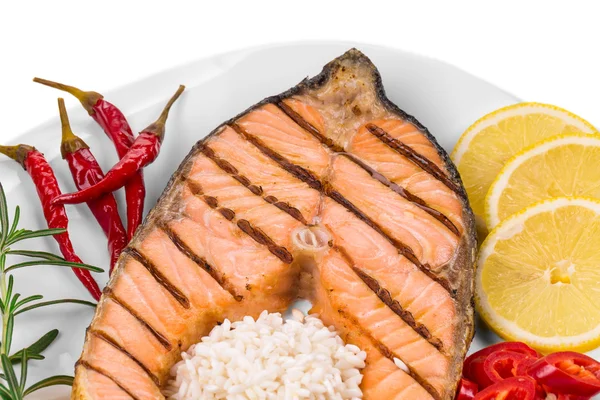 Salmon steak with rice, pepper and lemon — Stock Photo, Image