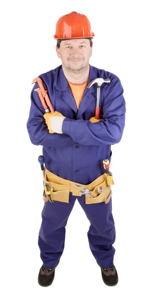 Trabajador sosteniendo martillo y llave inglesa . — Foto de Stock