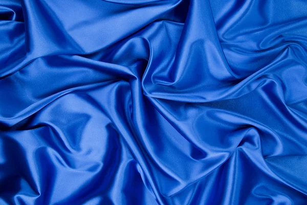 Soft folds of deep blue silk cloth. — Stock Photo, Image