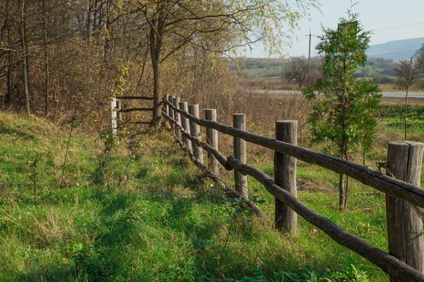 Wooden fence along the road — Stock Photo, Image